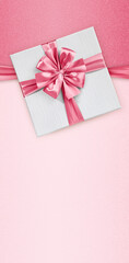 Wall Mural - Mothers day gift card, box with pink shiny ribbon bow, isolated on glittering pink background, blank template layout with copy space, top view and also for women's day or greetings card
