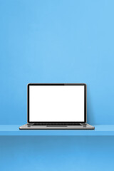 Laptop computer on blue shelf. Vertical background