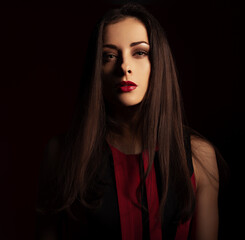 Wall Mural - Beautiful bright makeup woman with red lipstick  on dark red background with empty copy space. Closeup