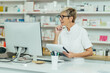 © Zamrznuti tonovi - Portrait of a beautiful senior female pharmacist working in a pharmacy
