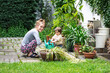 © Alexander - young mother and her toddler child are doing garden work with a watering can