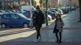 Fototapeta Miasto - Mother and Daughter enjoying together. A pretty young Latin woman enjoys a girls' outing with her young daughter to the mall, the park and around the city. Concept single parent family.
