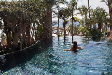 Canvas Print - Woman enjoying holidays at beach hotel resort.