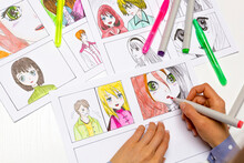 An Artist Draws A Storyboard Of An Anime Comics Book. Manga Style. The Designer Animator Draws With A Watercolor Brush With A Pen The Characters Of A Color Sketch Of The Cartoon.