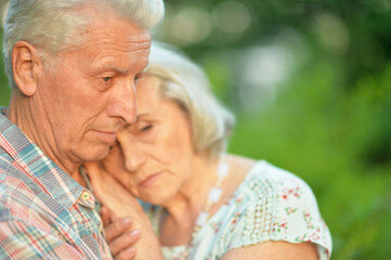 Sticker - Unhappy senior couple posing in the summer park