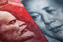 Close-up Of A Chinese Yuan And A Russian Ruble Banknote