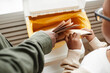 © Seventyfour - Top view close up of African-American father and son putting paper in recycling bins at home, copy space