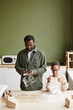© Seventyfour - Vertical portrait of African-American Father and son preparing household waste for recycling and cutting out labels