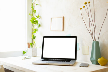 Wall Mural - Laptop with blank screen on a table.	
