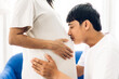 © Art_Photo - Romantic sweet asian couple husband hugging and smiling beauty asian pregnant wife.Man expecting with woman pregnancy hold and kiss to baby in belly at home