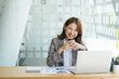 © PaeGAG - Asian woman working on a laptop computer,Working in the office with laptop concept,Young Asian woman starting a business using a laptop computer.