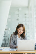 © PaeGAG - Asian woman working on a laptop computer,Working in the office with laptop concept,Young Asian woman starting a business using a laptop computer.
