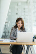 © PaeGAG - Asian woman working on a laptop computer,Working in the office with laptop concept,Young Asian woman starting a business using a laptop computer.