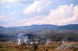 Mountains view landscape on blue sky background with smoke from burning at rice field for agriculture in Chiang Mai , Thailand