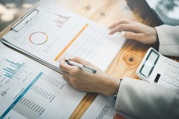 Asian accountant woman working audit budget and finance of company on wooden desk in office. consult, business, tax concept.