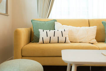 Wall Mural - Modern living room interior with stylish comfortable yellow sofa and green and white pillow on it.