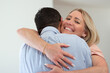 © KAMPUS - Happy loving wife hugging husband. Portrait of fair-haired mid adult woman embracing dark-haired man. Family, love concept