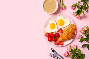 Healthy breakfast with eggs hearts and cup of coffee on pink background