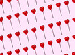 © Westend61 - Pattern of heart shaped lollipops flat laid against pink background