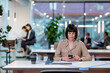 © Westend61 - Businesswoman texting on smart phone in office