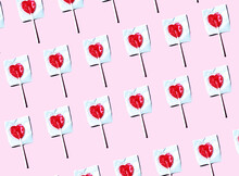 Pattern Of Heart Shaped Lollipops Flat Laid Against Pink Background