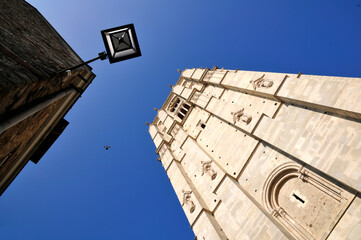 Wall Mural - Viewpoint of bell tower of the roman cathedral of Saint Julien at Le Mans on blue sky background, Pays de la Loire region in north-western France