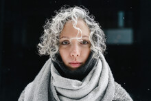 Woman With Gray Curly Hair Wrapped In Gray Scarf