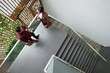 © DragonImages - Business people standing on stairs, drinking morning coffee and discussing work