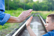 © Kostia - A Hands of happy parent and child on nature on the road in park background