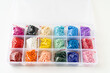 © Maria - colorful beads in the container with cells. set for creativity and needlework. Convenient storage of beads.