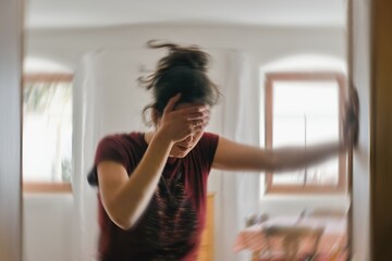 blured photo of a woman suffering from vertigo or dizziness or other health problem of brain or inne