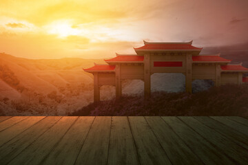 Wall Mural - Wooden floor with a view of Chinese pavilion gate with red roof on the hill