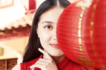 Poster - Asian Chinese woman in a cheongsam dress holding Chinese lantern