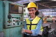 © FotoArtist - Factory Female Industrial Engineer Works in metal working factory, Inside the Heavy Industry. Portrait of working female industry technical worker or engineer woman working in an industrial.
