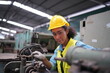 © FotoArtist - Female apprentice in metal working factory, Portrait of working female industry technical worker or engineer woman working in an industrial manufacturing factory company.