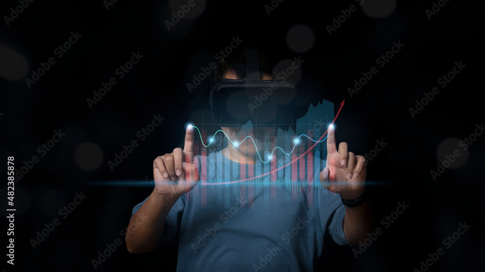 Man wearing VR Headset showing growing virtual hologram stock market ...