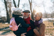 © hedgehog94 - Grandma and grandpa enjoy with their sweet granddaughter on a sunny winter day.
