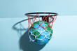 © ADDICTIVE STOCK - Small Earth ball in basketball hoop