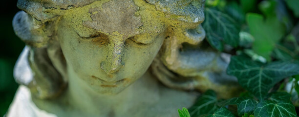 Canvas Print - Crying angel of death. Ancient statue of sad angel as symbol of pain, fear and end of life. Horizontal image.