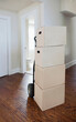 © Mint Images - Moving house, relocation, cardboard boxes piled up in a house