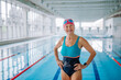 © Halfpoint - Active senior woman looking at camera and smiling after swim in indoors swimming pool.