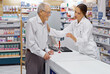 © Yuri Arcurs/peopleimages.com - Assuring clients are informed. Shot of a young pharmacist helping an elderly customer at the prescription counter.