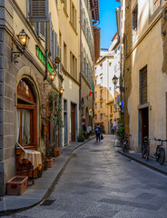Fototapete - Narrow street with old trattoria in Florence, Tuscany, Italy. Architecture and landmark of Florence. Cozy Florence cityscape