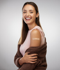 Wall Mural - Vaxxication, here I come. Shot of a young woman standing alone in the studio after getting vaccinated.