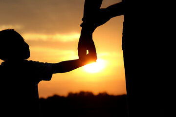 happy dad with a child in the park outdoors silhouette