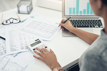 Sticker - Her business is under audit. Closeup shot of an unrecognisable businesswoman calculating finances in an office.