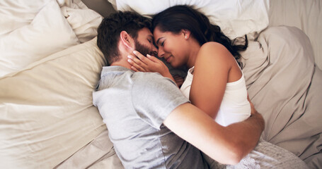 Poster - You're my safe space. Shot of an affectionate young couple embracing in bed at home.