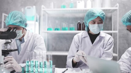 Wall Mural - medical scientist team are working on science laboratory research term by using microscope and scien