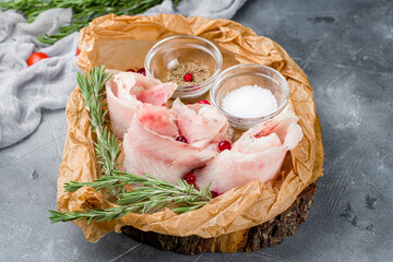 Canvas Print - stroganina sliced on the board with salt and pepper on grey table