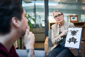 Canvas Print - Gaining access into the subconscious mind. Shot of a mature psychologist conducting an inkblot test with her patient during a therapeutic session.